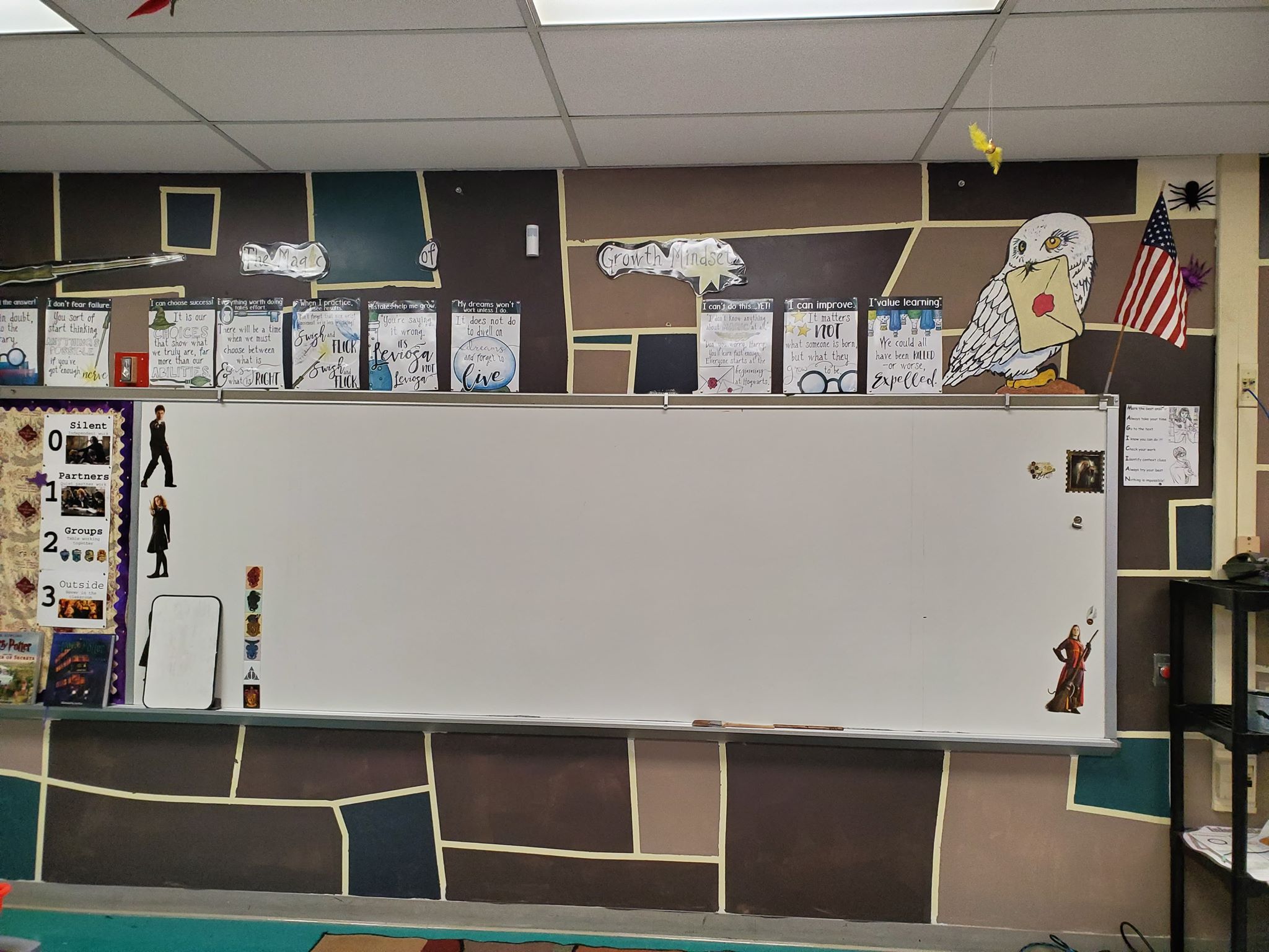 Classroom white erase board surrounded by Hedwig and various motivational pages from Harry Potter.