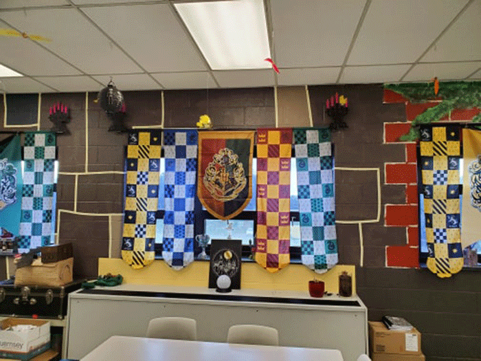 House banners over the window from Hufflepuff, Ravenclaw, Gryffindor, and Slytherin.