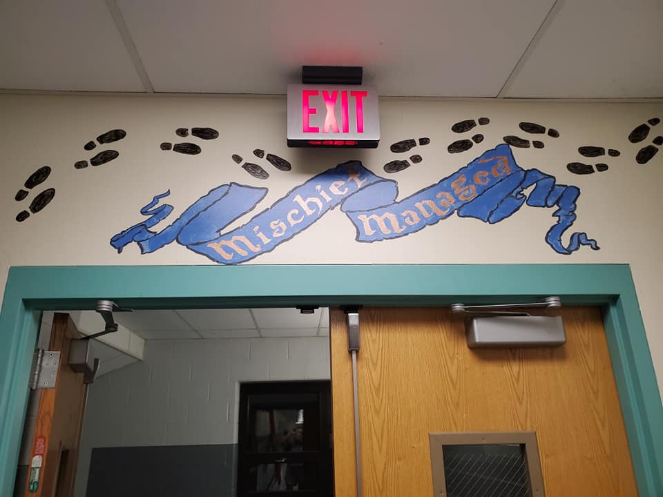 Mischief managed and footprints are painted above the exit.