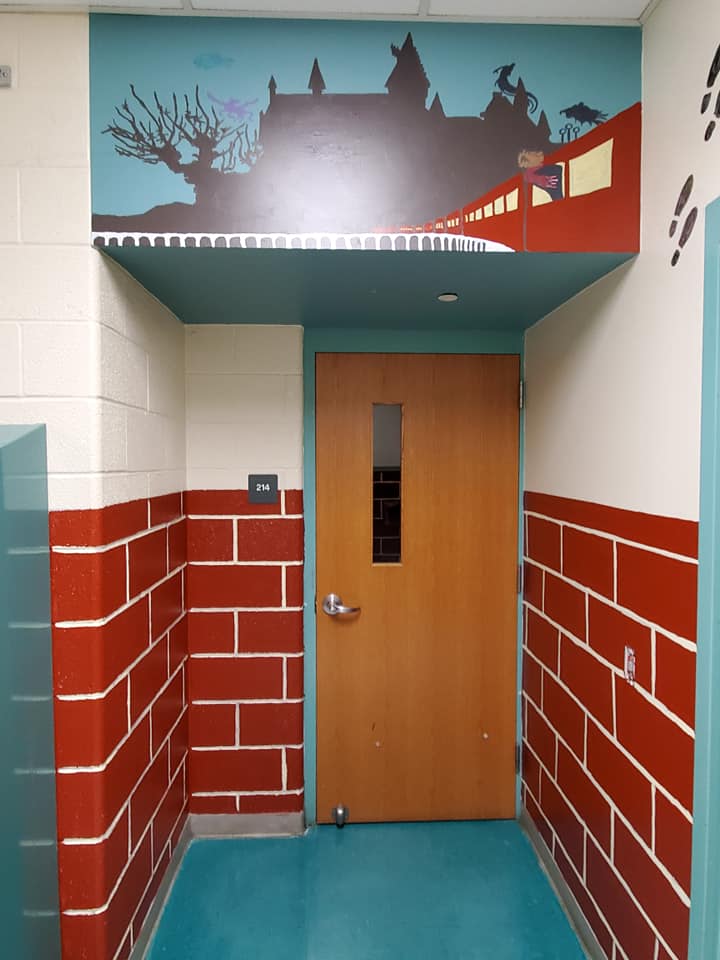 Painted bricks leading to classroom with the Hogwarts Express train and castle above the door.