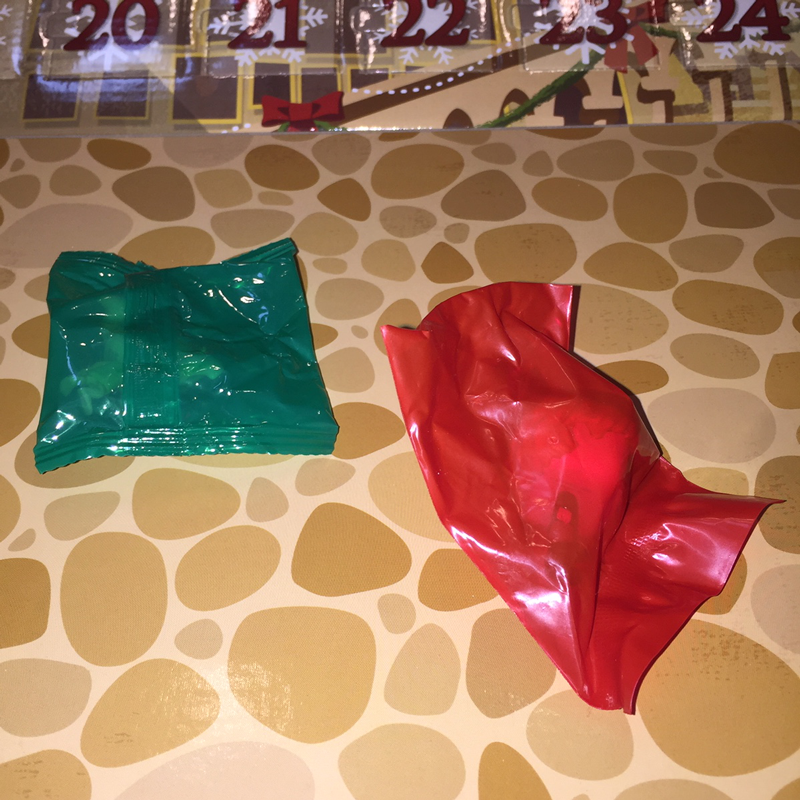 The red and green packaging that the figures are wrapped in