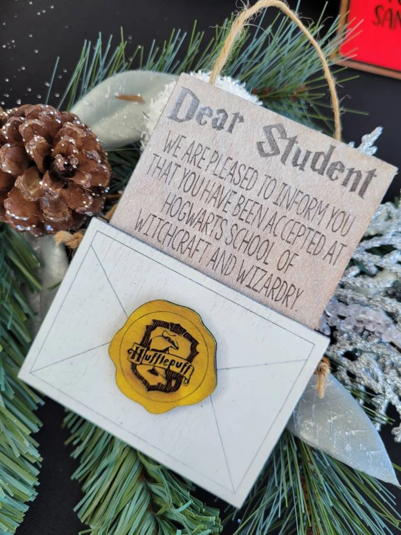 Hogwarts letter ornament that is customized with one of the four Hogwarts houses, name, and year.