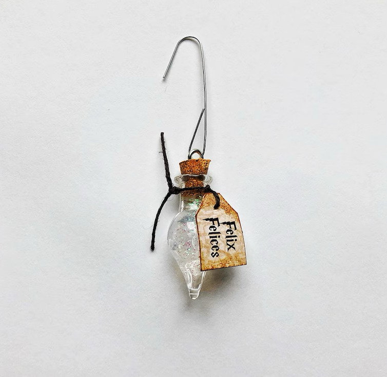 Small Christmas ornament that looks like a vial of Liquid Luck