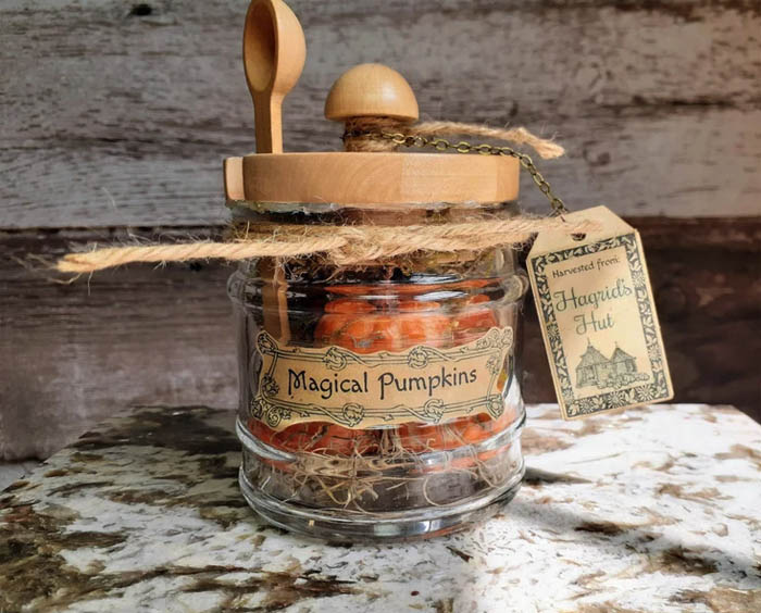 Glass jar with orange pumpkins inside