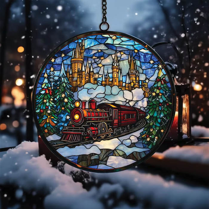 The Hogwarts Express train in the snow with Christmas trees and Hogwarts castle in the background